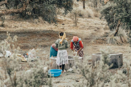 SIMIEN MOUNTAIN, ETHIOPIA, APRIL 25th.2019, Ethiopian women wash clothes in the traditional way outdoors in Simien Mountains, Ethiopia, April 25. 2019のeditorial素材