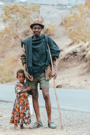 AMHARA REGION, ETHIOPIA, APRIL 22.2019, Ethiopian herdsman man with daughter near Gondar city. Amhara region, Ethiopia, April 22. 2019のeditorial素材