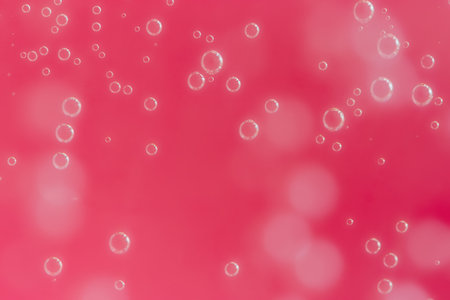abstract background with sparkle in red juice water, drops on glass for background or backdrop....