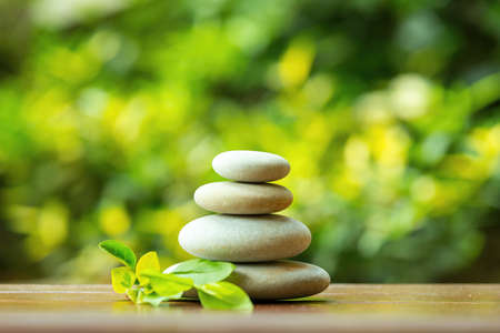 balancing pile of pebble stones, like ZEN stone, outdoor in springtime, spa wellness tranquil scene concept, soul equanimity mental calmness pictureの写真素材