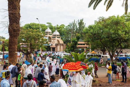 Azezo, Amhara Region, Ethiopia - April 21, 2019: Orthodox Christian people white dressed walk to mass on the street during easter holiday. Bahir dating in Dar, Ethiopiaのeditorial素材
