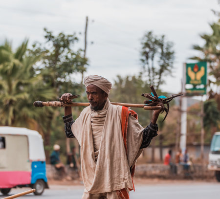 Adis Zemen, Ethiopia - April 22, 2019: Old ethiopian farmer on the street of Adis Zemen, Ethiopia, Africaのeditorial素材