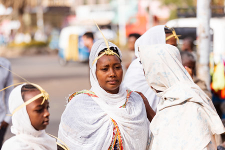 Azezo, Amhara Region, Ethiopia - April 21, 2019: Orthodox Christian woman white dressed walk to mass on the street during easter holiday. Bahir dating in Dar, Ethiopiaのeditorial素材