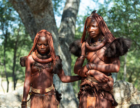 NAMIBIA, OMUSATI REGION, MAY 7: Portrait of two Himba woman with traditional hairstyle and necklaces...