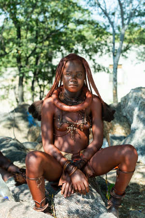 NAMIBIA, OMUSATI REGION, MAY 7: Portrait of Himba woman with traditional hairstyle and necklaces...