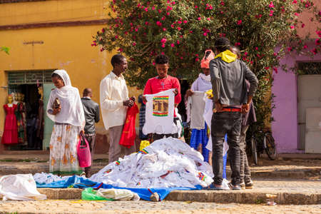 AXUM, ETHIOPIA, APRIL 27th.2019: Tigray native people in street market with clothes in center of...