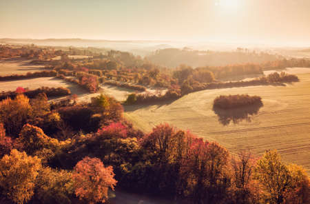 Aerial view of autumn sunrise countryside, traditional fall landscape with rising sun in Central europe. Foggy and misty sunrise. Frozen landscape from bird eye. Czech Republic, Vysocina highlandの写真素材