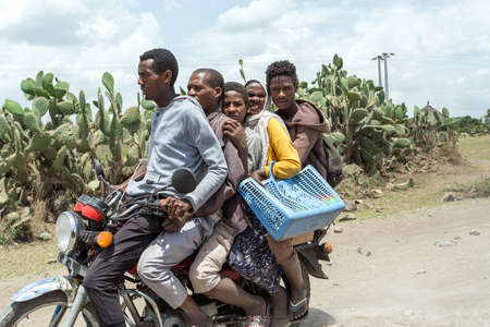 Oromia Region, Ethiopia - May 16, 2019: Ordinary people, family travel on bike in Ethiopian countryside. Everyday life on Ethiopia, Oromia Region, Ethiopia, Africaのeditorial素材