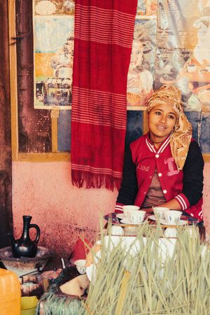 DEMEBECHA, ETHIOPIA, APRIL 20.2019. Local Ethiopian woman prepare traditional bunna coffee in city Demebecha, Ethiopia, April 20. 2019のeditorial素材