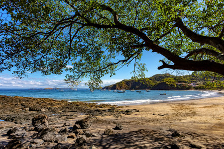 Playa Ocotal with Pacific ocean waves on rocky shore, El Coco Costa Rica. Famous snorkel beach. Picturesque paradise tropical landscape. Pura Vida concept, travel to exotic tropical country.の写真素材