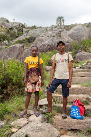Andringitra, Madagascar - November 16, 2022: Young man and woman standing on a rocky trail in a mountainous area. Young couple walking on a rocky trail in a mountainous area wearing flip-flops.のeditorial素材
