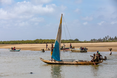 Morondava, Madagascar - November 3rd 2022: A fisherman sails back from the sea to the river on a sailboat in Morondavaのeditorial素材