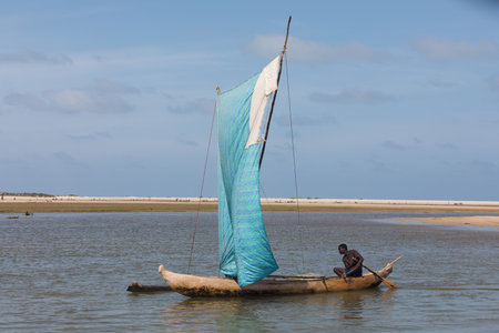 Morondava, Madagascar - November 3rd 2022: A fisherman sails back from the sea to the river on a sailboat in Morondavaのeditorial素材