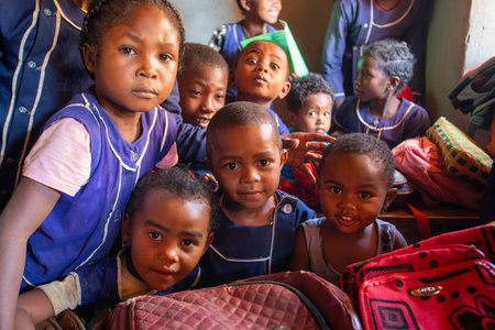 Vohitsaoka, Ambalavao, Madagascar - November 17, 2022: Happy Malagasy school children students in classroom. School attendance is compulsory, but many children do not go to school.のeditorial素材