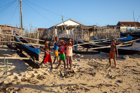 Anakao, Madagascar - November 21, 2022 - Group of Malagasy children frolicking on the beach near the fishing village of Anakao.のeditorial素材