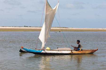 Morondava, Madagascar - November 3rd 2022: A fisherman sails back from the sea to the river on a sailboat in Morondavaのeditorial素材