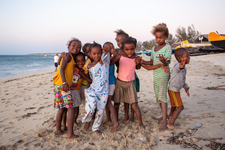 Anakao, Madagascar - November 21, 2022 - Group of Malagasy children frolicking on the beach near the fishing village of Anakao.のeditorial素材