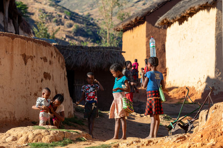 Lakanga, Andringitra mountain, Madagascar - November 15, 2022: , Madagascar - November 15, 2022: Malagasy girls from Lakanga village delivering water for cooking in the morning.のeditorial素材