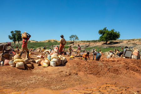 Ihosy, Ilakaka, Madagascar - November 20, 2022: Local people mine for gems and pan for gold in a river. The town is a major center of sapphire production and trade.のeditorial素材