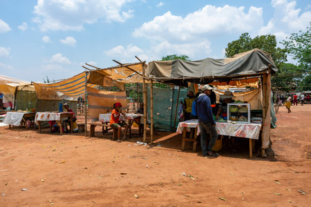 Mandoto, Madagascar - November 9th, 2022: A bustling street market in Mandoto city with fast food in street marketplace.のeditorial素材