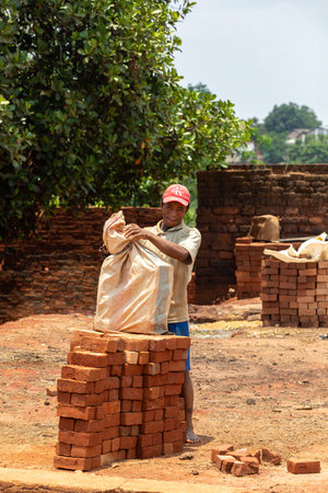 Mandoto, Madagascar - November 9th 2022: Street vendor selling handmade building bricks. This is a...