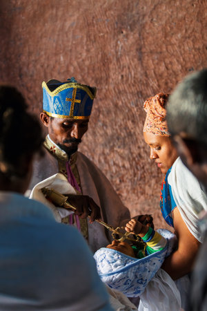 Lalibela, Ethiopia - May 1, 2019: Orthodox Christian baptism ceremony at St. George Church captures a sacred moment in Ethiopian spiritual life.のeditorial素材
