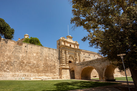 Entrance stone bridge and gate to the fortified medieval city of Mdina called silent city in the Northern Region of Malta.の写真素材