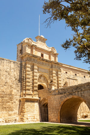 Entrance stone bridge and gate to the fortified medieval city of Mdina called silent city in the Northern Region of Malta.の写真素材