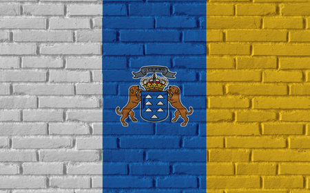 Canary Islands country national flag painting on old brick textured wall with cracks and concrete concept 3d rendering image realistic background bannerの写真素材