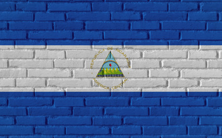 Nicaragua country national flag painting on old brick textured wall with cracks and concrete concept 3d rendering image realistic background bannerの写真素材