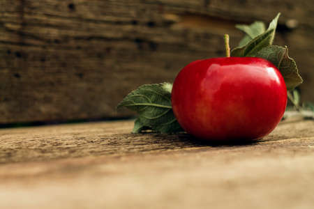red apple closeup on a wooden backgroundの写真素材