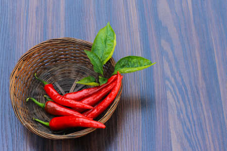 Red hot pepper with leaves on a wooden backgroundの写真素材