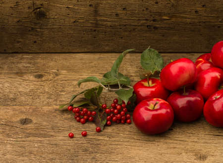red apples with leaves and snowball on a wooden backgroundの写真素材