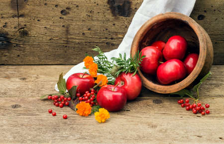 red apple in a clay pot on a wooden backgroundの写真素材