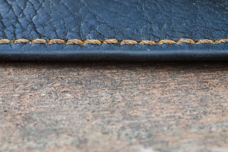 background of old skin with a seam on woodの写真素材