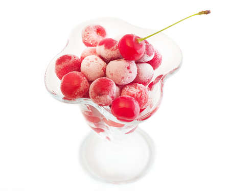 frozen cherries in the cup  on a white background