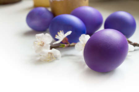 Lilac easter egg on a light background on a blurred background of other eggs. Shallow depth of fieldの写真素材