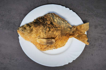Carp baked fish on a white plateの写真素材