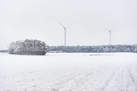 Wind turbines in winter season with snow
