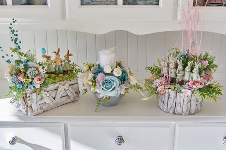 Artificial flower arrangements on white furnitureの写真素材