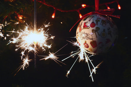 Sparkler burning on a Christmas tree.Christmas tree decoration and sparkler close-upの写真素材