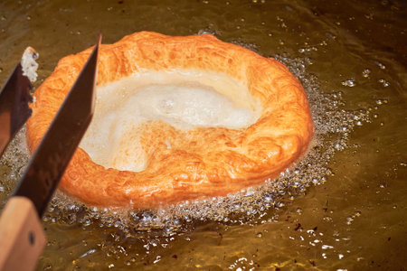 Langos, a typical Hungarian food. Deep fried flatbread in oil.の写真素材
