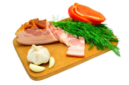 bacon, dill, pepper and garlic on a board isolated on white backgroundの写真素材