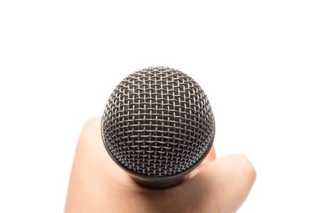 hand holding microphone isolated on whiteの写真素材