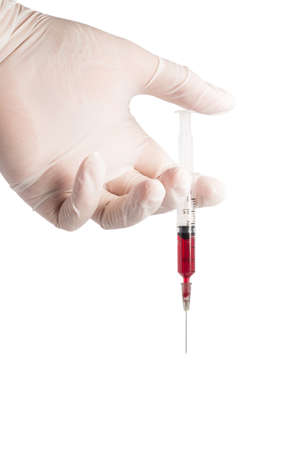 hand hold syringe with blood on white backgroundの写真素材