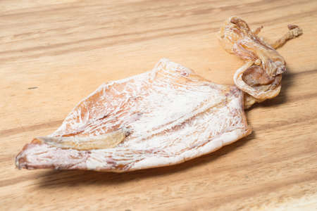 dried squid on wooden plateの写真素材