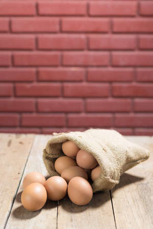 fresh eggs on wooden table background