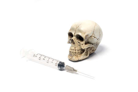 skull with syringe isolated on white backgroundの写真素材