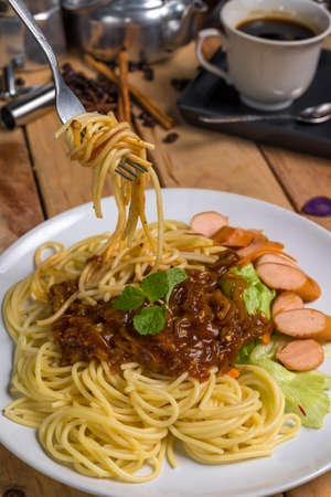 spaghetti with black pepper sauce on wood tableの写真素材