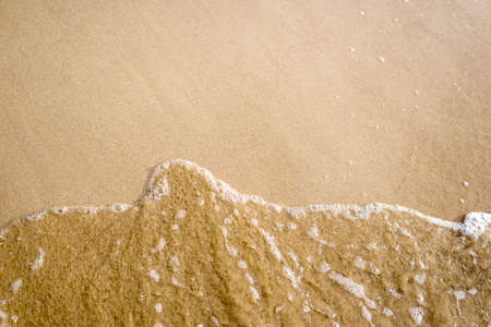 sand beach with wave for backgroundの写真素材